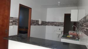 a white kitchen with a sink and a toilet at Residencial Caetano em Porto de Galinhas in Porto De Galinhas +7 photos