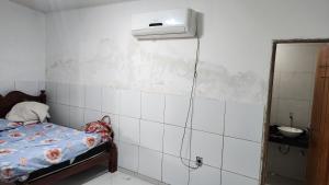 a room with a bed and a heater on the wall at Residencial Caetano em Porto de Galinhas in Porto De Galinhas