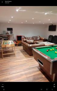 a living room with a pool table and a couch at Old Chapel House Tetney Lock in Grimsby