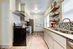 a kitchen with a sink and a stove at Lincoln Lodge B Near OU Med Bricktown Arena in Oklahoma City