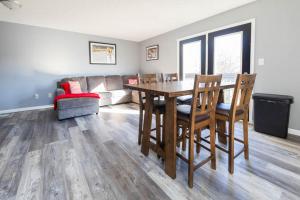 a living room with a table and chairs and a couch at Little 500 Quarters in Bloomington