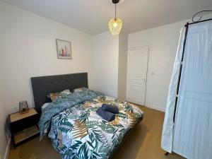 una camera da letto con un letto con un piumone colorato di ღ Hubble • Au cœur de Saintes, Spacieux & Wifi a Saintes