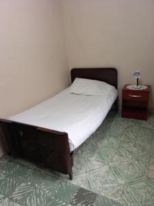 a bed in a room with a nightstand and a bed sidx sidx sidx sidx at Martin Barroso in Yacuiba