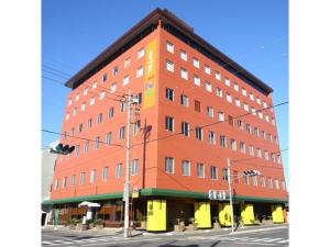 a large red building on the corner of a street at Hotel 1-2-3 Maebashi Mercury - Vacation STAY 01042v in Maebashi