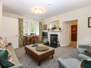 a living room with a couch and a table at Middle Cottage - Tarvit in Cupar