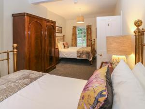 a bedroom with two beds and a dresser at Middle Cottage - Tarvit in Cupar