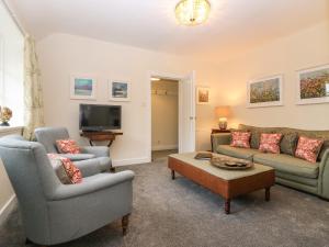 a living room with two couches and a tv at West Cottage - Tarvit in Cupar