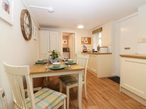 a kitchen and dining room with a table and chairs at West Cottage - Tarvit in Cupar