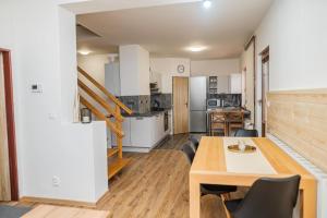 a kitchen and dining room with a table and chairs at Vilka Viktorka in Velké Losiny