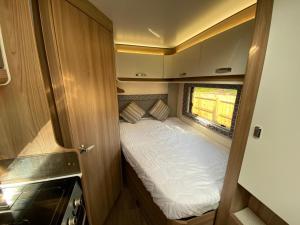a small bed in the back of an rv at Swift Escape 664 - 4 Berth Motorhome in Kirton