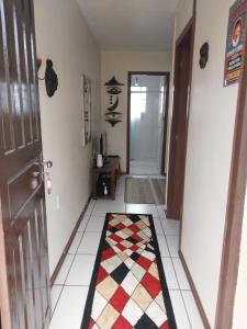 a hallway with a door and a rug on the floor at Apartamento no centro in Canela
