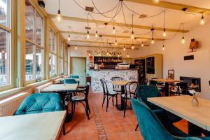 a restaurant with tables and chairs and a bar at Botanický dvor in Banská Štiavnica