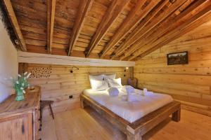 a bedroom with a bed in a wooden room at ESCALE CAB'ÂNE in Mittlach