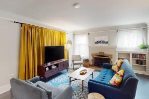 a living room with a blue couch and a tv at Sunnyside Up in Seattle