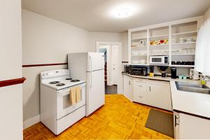 a kitchen with a white refrigerator and a sink at Sunnyside Up in Seattle