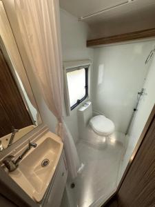 a small bathroom with a sink and a toilet at Swift Escape 646 Motorhome in Kirton