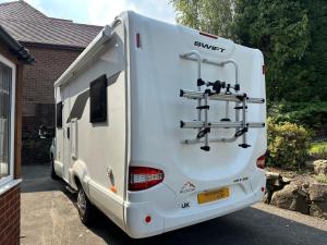 a white trailer parked in front of a house at Swift Escape 646 Motorhome in Kirton