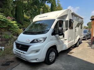 a white camper truck parked in a parking lot at Swift Escape 646 Motorhome in Kirton