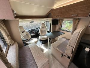 an interior view of an rv with a table and chairs at Swift Escape 646 Motorhome in Kirton