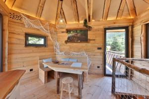 a wooden cabin with a table and a bench at ESCALE CAB'ÂNE in Mittlach +24 photos