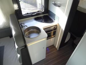 een kleine badkamer met een wastafel in een camper bij RollerTeam Zafiro 685 - 5 Berth Motorhome in Kirton