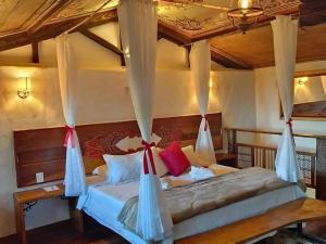 a bedroom with a bed with mosquito nets on it at Chalés Recanto do Sabiá in Lavras Novas