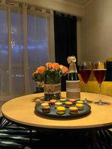 uma mesa com uma bandeja de donuts e copos de vinho em AVENUE DE CHAMPAGNE em Épernay