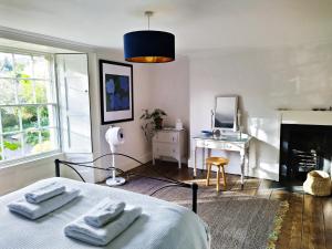a bedroom with a bed with two towels on it at Quay Street in Lostwithiel