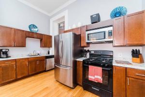 a kitchen with stainless steel appliances and wooden cabinets at Outdoor Space - Parking - 1st Floor - Walkable in Pittsburgh