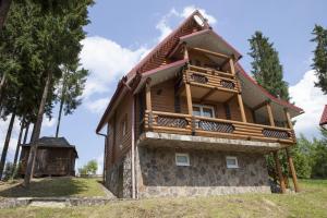 a log house with a porch and a balcony at Torba in Bukovel