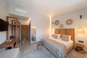 Postel nebo postele na pokoji v ubytování Oasis Hotel Prasonisi