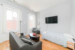 a living room with a couch and a bed at Parking - Walkable - GroupStays - Washer in Pittsburgh