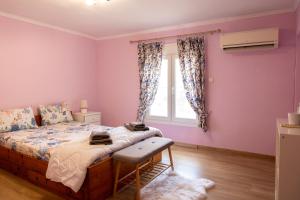 a bedroom with a bed and a window at Dream House in Xanthi