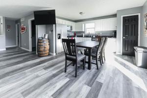 a kitchen with a dining room table and chairs at Hoosier Dugout Den in Bloomington