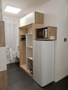 a kitchen with a microwave on top of a refrigerator at Appartamento vicino Lago di Garda, Peschiera, Gardaland in Ponti Sul Mincio