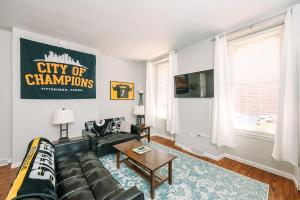 ピッツバーグにあるPittsburgh's Sports Suite- FREE driveway Parkingのソファとテーブルのあるリビングルーム