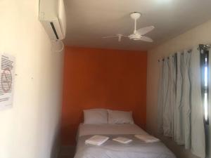 a bedroom with a bed and a ceiling fan at ROYAL CONTAINER HOTEL in Capitólio