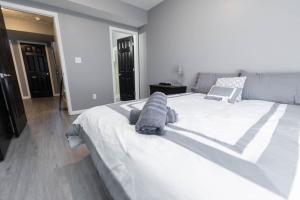 a bedroom with a large white bed with towels on it at IU Soccer HIdeaway in Bloomington