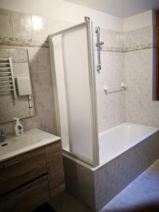 a bathroom with a shower and a tub and a sink at Chalet Luna in Caspoggio