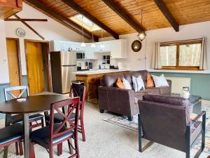 a living room with a couch and a table at White Mountain Escape - Ski Attitash in Bartlett