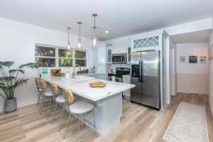 a kitchen with white countertops and stainless steel appliances at Del Playa #2 Condo in West End
