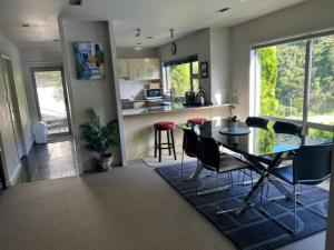 a kitchen and dining room with a table and chairs at Villa Sebastian - Large Modern Home in Wellington