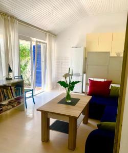 a living room with a table and a blue couch at Apartment Art Adriatic in Punat