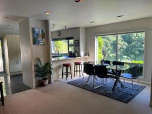 a kitchen and dining room with a table and chairs at Villa Sebastian - Large Modern Home in Wellington