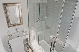 a bathroom with a shower with a glass door at The Trafalgar in Oakville