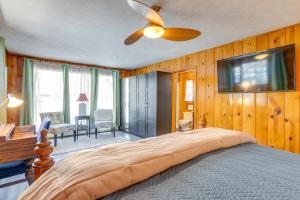 a bedroom with a large bed with a ceiling fan at Charming Idaho Springs Retreat on Chicago Creek! in Idaho Springs