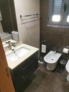 a bathroom with a sink and a toilet at Casa da Silva in Corroios +15 photos