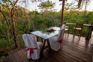 a wooden deck with a table and chairs on it at Marbella Retreats Casa Roja in Santa Cruz