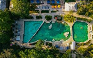 an aerial view of a pool with a resort at Chan-Kah Resort Village in Palenque