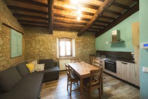 a kitchen and living room with a table and a couch at Agriturismo Fonte Belvedere in Collesalvetti